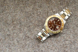 Rolex GMT-Master II luxury watch with brown dial and two-tone gold and steel bracelet