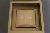 Gold Gucci watch box with luxury packaging for Swiss-made timepiece