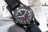 Vintage Heuer Bund SG 1550 flyback chronograph watch with black dial and leather strap