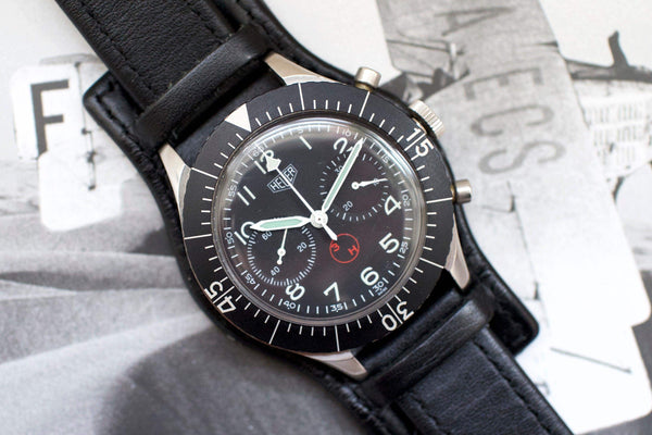 Vintage Heuer Bund SG 1550 flyback chronograph watch with black dial and leather strap