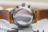 Close-up of vintage chronograph watch back with Bundeswehr engravings and leather strap
