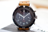 Vintage black dial chronograph watch with tan leather strap and bold white numerals