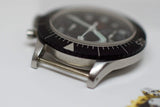 Close-up of a vintage stainless steel chronograph watch with a black rotating bezel