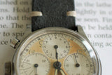 Vintage Swiss-made chronograph watch with aged dial and dark leather strap close-up