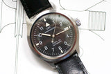 IWC Mark XII automatic men's pilot watch with black dial and leather strap on white schematic background