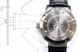 Close-up of the IWC Mark XII pilot watch caseback on black leather strap, showing engravings