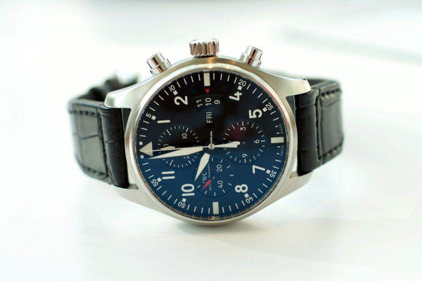 Luxury Swiss chronograph watch with blue dial, black leather strap, and silver case