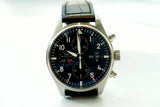 Stainless steel chronograph pilot watch with black dial and leather strap on white background