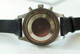 Close-up of luxury chronograph watch case back with black leather strap