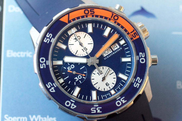 Blue and orange dive chronograph watch with subdials, date window, and rotating bezel