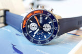 Blue and orange chronograph dive watch with rubber strap and dual subdials on display
