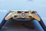 Side view of a stainless steel Swiss chronograph watch case with pushers and crown