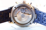 Close-up of luxury Swiss watch open caseback showing automatic movement and blue strap