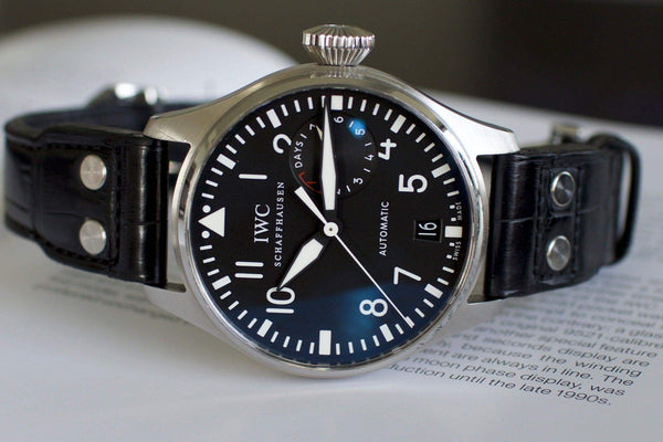 Close-up of IWC Big Pilot 5004 luxury Swiss watch with black dial and leather strap