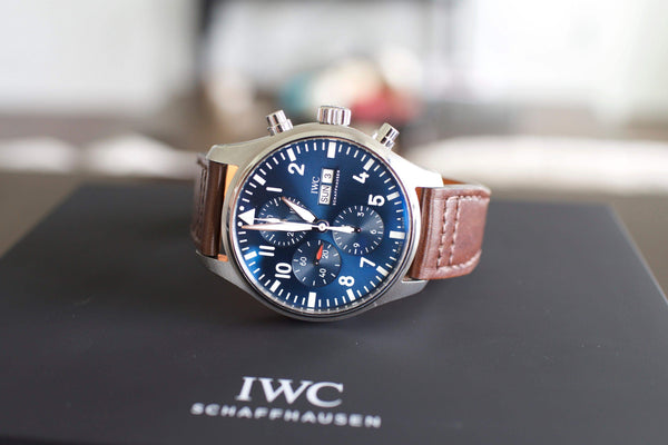 Luxury chronograph watch with blue dial, brown leather strap on black box