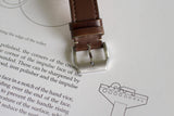 Brown leather watch strap with silver clasp on technical drawing and text