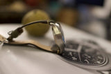 Side view of a luxury chronograph watch with black dial and leather strap on a table.