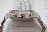 Side view of stainless steel chronograph watch with engraved crown and metal bracelet