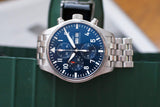 Stainless steel chronograph watch with blue dial, day-date window, and silver bracelet