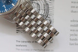 Luxury Swiss chronograph watch with blue dial and stainless steel bracelet close-up