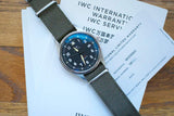 IWC Internatic luxury watch with olive green strap and warranty documents