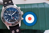 Stainless steel chronograph watch with black dial and world time bezel on green case