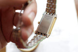 Close-up of the case back of a Jaeger-LeCoultre Reverso watch with a two-tone metal bracelet.