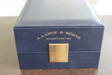 Luxury dark blue watch box with gold lettering and clasp, ideal for premium timepieces