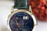 Close-up of luxury A. Lange & Söhne wristwatch with black dial and date display