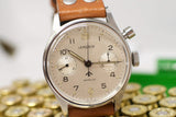 Vintage Lemania mono pusher chronograph watch with tan leather strap, close up