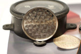 Close-up of stainless steel vintage watch case back with circular brushed finish