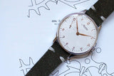 Limited edition Minerva men’s watch with white dial and green leather strap on a technical drawing