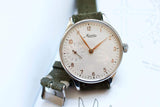 Minerva 140th Anniversary limited edition men's watch with white dial and green suede strap