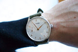 Minerva 140th anniversary limited edition men's watch with white dial and leather strap on wrist