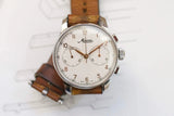 Vintage Minerva chronograph watch with a white dial and brown leather strap