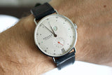 Luxury NOMOS Metro wristwatch with white dial, subdial, and black leather strap on wrist