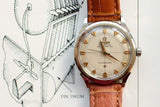 Vintage Omega Constellation automatic watch with a brown leather strap on a technical drawing.