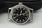 Vintage Omega Fat Arrow watch with black dial, Arabic numerals, and silver case