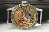Close-up of Omega watch movement with visible gears and vintage mechanical details