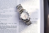 Omega Speedmaster luxury watch resting on technical documentation.