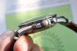 Side view of a luxury Swiss watch showing the crown and pushers