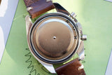Back view of a luxury Swiss watch with a brown leather strap and stainless steel case.