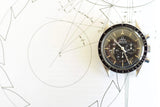 Omega Speedmaster Professional chronograph watch on technical drawing background