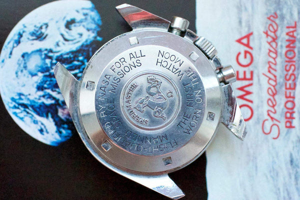 Close-up of Omega Speedmaster Professional Moonwatch case back with engraved text and emblem