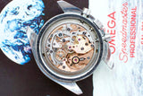Open caseback view of Omega Speedmaster Professional 145.022 watch movement, Earth background