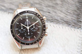 Omega Speedmaster Professional Moonwatch with black dial and tachymeter bezel on light background