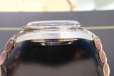 Side view of a stainless steel luxury watch with engraved detail saying 'ON THE MOON'.