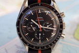 Omega Speedmaster Professional chronograph watch with black dial, orange accents, and tachymeter bezel