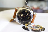 Luxury Panerai Luminor watch with brown leather strap, black dial, and polished case