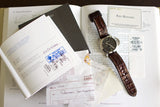 Luxury Panerai watch with brown leather strap displayed with warranty papers and certificates